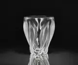Lalique Verrerie, An Ingrid vase
Lalique, Wingen-sur-Moder, designed 1960s, produced 1990s/2000s., Clear mould-pressed glass, patinated. Etched signature Lalique ® France. H 26.5, D