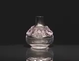 Lalique Verrerie, An Atossa vase
Lalique, Wingen-sur-Moder, designed by Marie-Claude Lalique, produced as of 1972., Clear and mauve mould-pressed glass, patinated. Etched signature Lalique France. With limescale traces to the interior. H