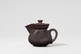 Otto Lindig, A small ceramic ewer with a lid by Otto Lindig (1895 - 1966), Red earthenware with dark brown to matte black gradient glaze, interior white