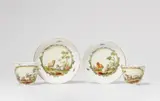 A pair of Berlin KPM porcelain cups and saucers with goats and sheep by Königliche Porzellanmanufaktur Berlin Kpm, offered Apr 2023