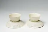 A pair of Meissen Böttger porcelain teabowls and saucers with vine decor by Meissen Royal Porcelain Manufactory, offered May 2022