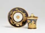 A Berlin KPM porcelain cup with a depiction of Cupid by Königliche Porzellanmanufaktur Berlin Kpm, sold May 2022