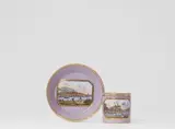 A Meissen porcelain cup and saucer with views of Albrechtsburg and Pillnitz Palace by Meissen Royal Porcelain Manufactory, sold May 2022