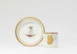 A Meissen porcelain cup and saucer commemorating King Friedrich August I's 50th jubilee by Meissen Royal Porcelain Manufactory, offered May 2022