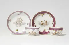 Andreas Oettner, Two Meissen porcelain cups and saucers with putto motifs