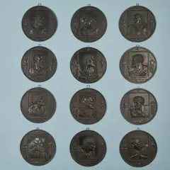 Leonhard Posch, A complete set of cast iron plaques with the 12 Apostles, Black patinated cast iron. Holy Spirit, two with vase motifs above and still lifes below. Engraved with letters and numbers. D c