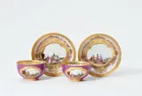 Meissen Royal Porcelain Manufactory, A pair of magnificently painted Meissen porcelain tea bowls and saucers with purple ground