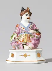 Meissen Royal Porcelain Manufactory, A rare Meissen porcelain figure of a seated male pagode