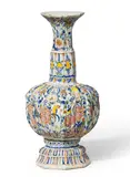 Gerhard Wolbeer, A ribbed Berlin faience vase with peacock decor