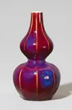 Hermann Seger, A Berlin KPM Seger porcelain gourd-form vase, Unidentified model of octagonal section with oxblood red copper oxide glaze. Pale blue sceptre mark with Sgr.P., impressed S and oo. H
