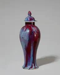 Hermann Seger, A Berlin KPM porcelain vase and cover with an experimental glaze, Unidentified model with original lid. With a dribble glaze in oxblood red and plum. Blue sceptre mark with Sgr.P., incised M and 40. H