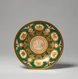 Louis Henri Rivet de la Grange, A Berlin KPM porcelain plate with green porphyry ground and trophies