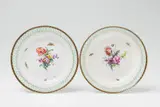 A pair of Berlin KPM porcelain dessert plates with naturalistic flowers by Königliche Porzellanmanufaktur Berlin Kpm, offered Apr 2018