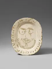 Visage d'homme by Pablo Picasso, 1955, Oval ceramic plate. White clay, patinated in grey, with three-dimensional relief decor, painted in light brown and ivory, sold Dec 2017