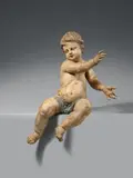 Ferdinand Dietz, A carved wooden figure of a seated Putto