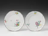 A pair of hexagonal Strasbourg faience plates with floral overglaze decor by Maria Seraphia von Löwenfinck, offered Nov 2016