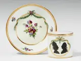 Gottlob Samuel Mohn, A Berlin KPM porcelain cup with silhouetted and floral decor