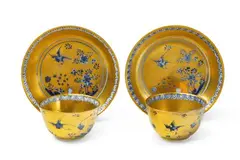 Meissen Royal Porcelain Manufactory, A pair of Meissen porcelain tea bowls with gold overpainted rock and bird decor