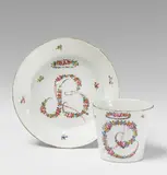 Nymphenburg, A Biedermeier Nymphenburg porcelain teacup and saucer with monograms.