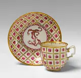 A Vienna porcelain teacup and saucer with floral trellis decor. by Imperial Vienna Porcelain Manufactory, sold Nov 2015