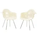 Charles and Ray Eames, PAIR OF 'DAX' CHAIRS FOR HERMAN MILLER, Parchment coloured fibreglass shells with arms on aluminium legs. Manufacturer logo to underside of seat shell