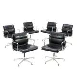 SIX 'EA433' SOFT PAD SIDE CHAIRS FOR HERMAN MILLER by Charles and Ray Eames, Black padded leather over an aluminium and metal frame on universal five star base. Herman Miller mark embossed to frame, sold Nov 2025