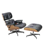 LOUNGE CHAIR AND OTTOMAN FOR HERMAN MILLER by Charles and Ray Eames, Upholstered in black leather with veneered, moulded ply shell on aluminium star swivel base. Manufacturer badge present , sold Jul 2025