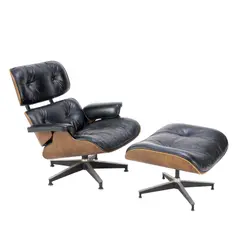 Charles and Ray Eames, LOUNGE CHAIR AND OTTOMAN FOR HERMAN MILLER, Upholstered in black leather with veneered, moulded ply shell on aluminium star swivel base. Manufacturer badge present to underside