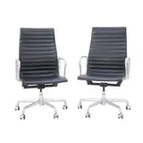 PAIR OF 'GROUP MANAGEMENT' CHAIRS FOR HERMAN MILLER by Charles and Ray Eames, High back aluminium and steel frame with ribbed black leather upholstery on five star swivel castor base. Height and til, sold Jul 2025
