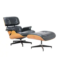 LOUNGE CHAIR AND OTTOMAN FOR HERMAN MILLER by Charles and Ray Eames, Upholstered in black leather with veneered, moulded ply shell on aluminium star swivel base. Manufacturer badge present , sold Feb 2025