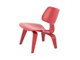 Charles and Ray Eames, RED LCW CHAIR FOR HERMAN MILLER, Red stained moulded plywood with rubber shock mounts. Stamps and stickers present to underside