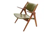 SAWBACK ARMCHAIR by Hans J. Wegner, Solid oak with distressed original green leather upholstery, sold Nov 2021