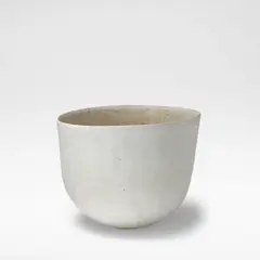 Asymmetrical bowl by John Ward, circa 1990, Stoneware, mottled cream and pale blue glazes over a softly pitted and textured body, sold Mar 2026
