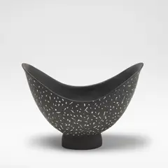 Felicity Aylieff, Flared bowl, circa 1990, Earthenware, decorated with white spots against a white ground, raised on an oval pedestal foot