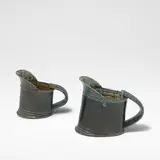 Walter Keeler, Two jugs, Stoneware, blue salt glazes with running olive green and brown salt glazes to interiors, each mounted with a strap handle