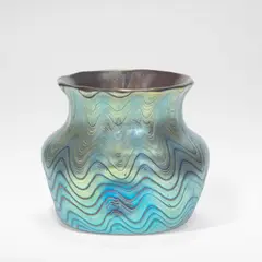 'Rubin Phaenomen' vase circa 1898 by Loetz, Phänomen Gre 6893, ruby glass with pulled iridescent bands in a wave pattern, the squat body with impressed sides, sold Jun 2026