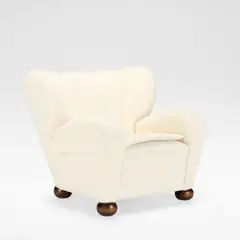 Märta Blomstedt, 'Aulanko' armchair, designed 1939, Upholstered throughout in white boucle with piped details, raised on stained wooden bun feet