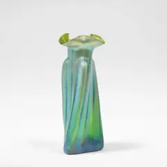 'Phänomen' vase by Loetz, circa 1900, Blown and iridescent glass with waved design, the twisted body rising to a pinched trefoil rim, sold Mar 2026