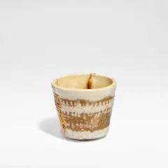 Small pot by Lucie Rie, circa 1949, Stoneware, poured cream and brown glazes over an ochre and unglazed body, sold Mar 2026