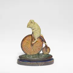 George Tinworth, for Doulton Lambeth, circa 1885, Stoneware, green, blue and brown glazes, modelled as a mouse riding a penny farthing bicycle