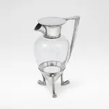 'Crow's Foot Decanter', model no. 2045, designed 1879 by Christopher Dresser, Electroplated metal and clear glass, the spout and collar joined to the base with a curved handle, raised on three crow', sold Dec 2025