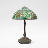 Tiffany Studios, 'Woodbine' leaded glass table lamp, circa 1905, Leaded glass and patinated bronze, the hemispherical shade raised on a ribbed base