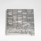Line Vautrin, 'Je t'aime beaucoup' poudrier, circa 1946, Silvered-bronze, mirror and fabric, the lid modelled in shallow relief with a game board, three dice and 't'M'