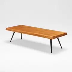 Coffee table, designed 1953, manufactured circa 1960 by Charlotte Perriand, Elm and lacquered steel, the rectangular top with a bevelled edge, raised on tapering supports, offered Dec 2025