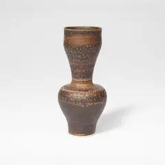 'Byzantine' vase by Lucie Rie, circa 1975, Porcelain, golden manganese glaze with sgraffito bands to the shoulder, interior of rim and underside, sold Dec 2025