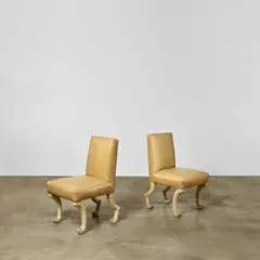 John Dickinson, Pair of 'Etruscan' Chairs, carved walnut, craquelure paint, calf leather upholstery