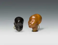 Two heads by Hagenauer, bronze, patinated dark, brass, wood; 1 head marked on the bottom with "WHW" and "HAGENAUER/Vienna", offered Jun 2024
