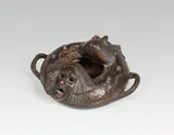Gustav Gurschner, Ashtray, bronze, cast, patinated; removable top with masks, 2 handles on the sides; inscribed on the lower surface: "125/M."