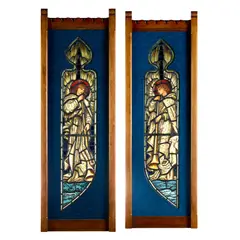 Edward Burne-Jones, 'TWO ANGELS WITH LONG TRUMPETS', A PAIR OF STAINED GLASS PANELS, 1915, 1915, leaded and painted glass