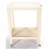Off White Snakeskin Telephone Table. by Karl Springer, 1987, Karl Springer (1931-1991). Two-tier rectangular design, with brass handles to upper tier, to both ends, on brass wheels, sold Jun 2020